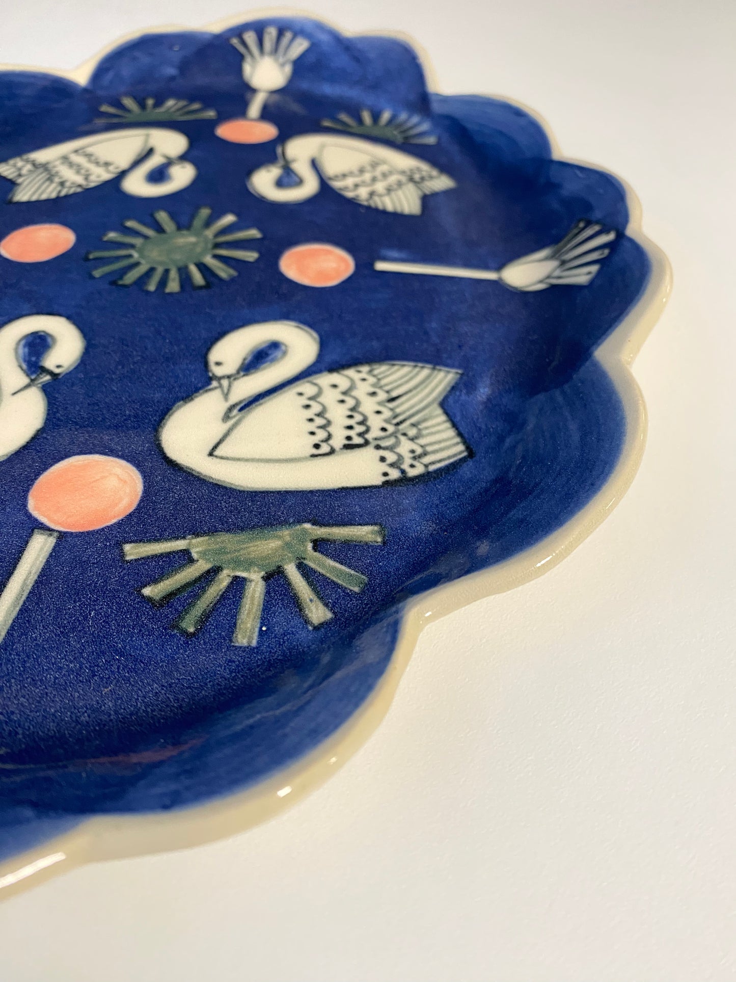 Ceramic Scallop Edge Platter with Swans Pattern against Blue Background