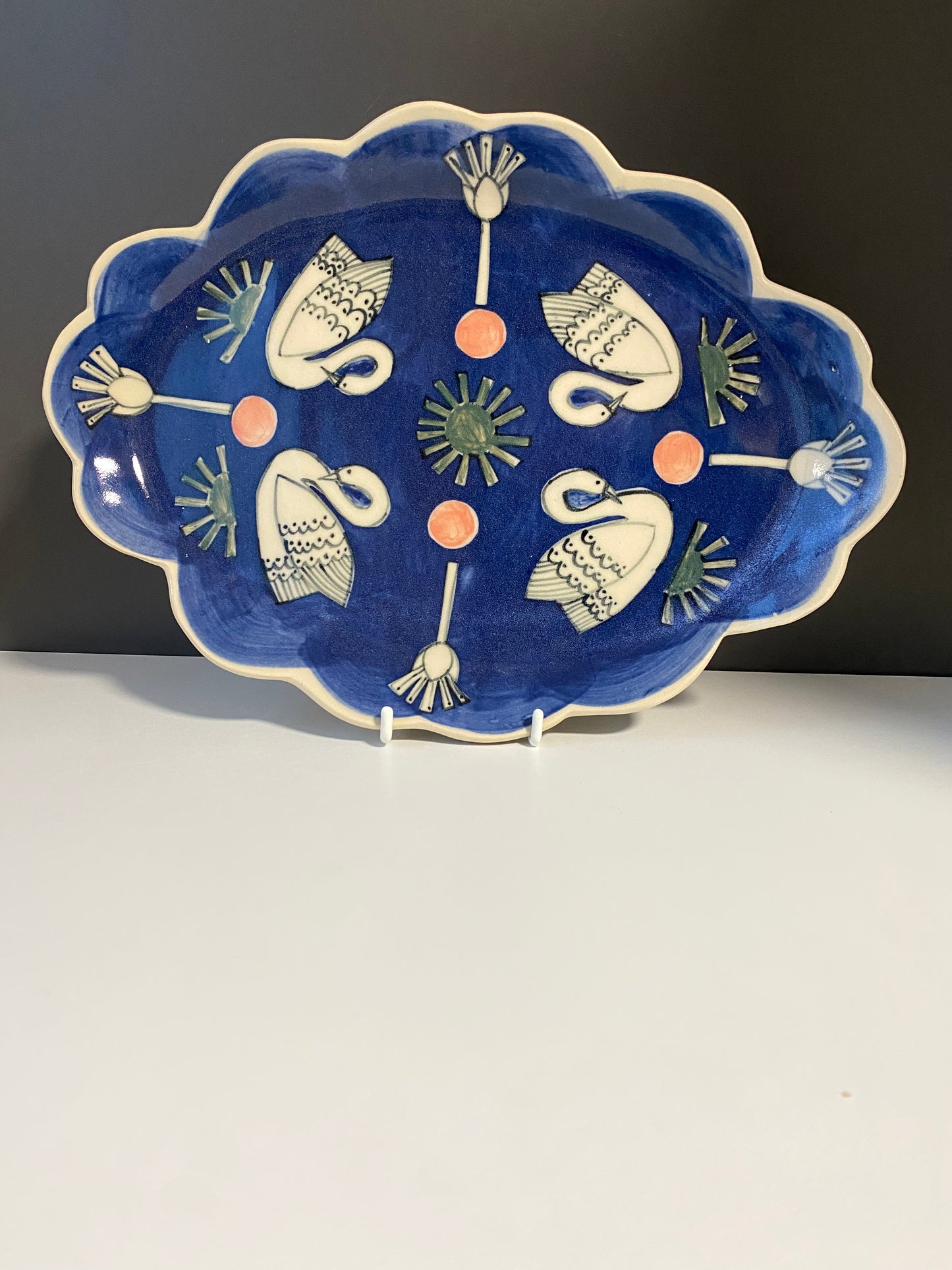 Ceramic Scallop Edge Platter with Swans Pattern against Blue Background