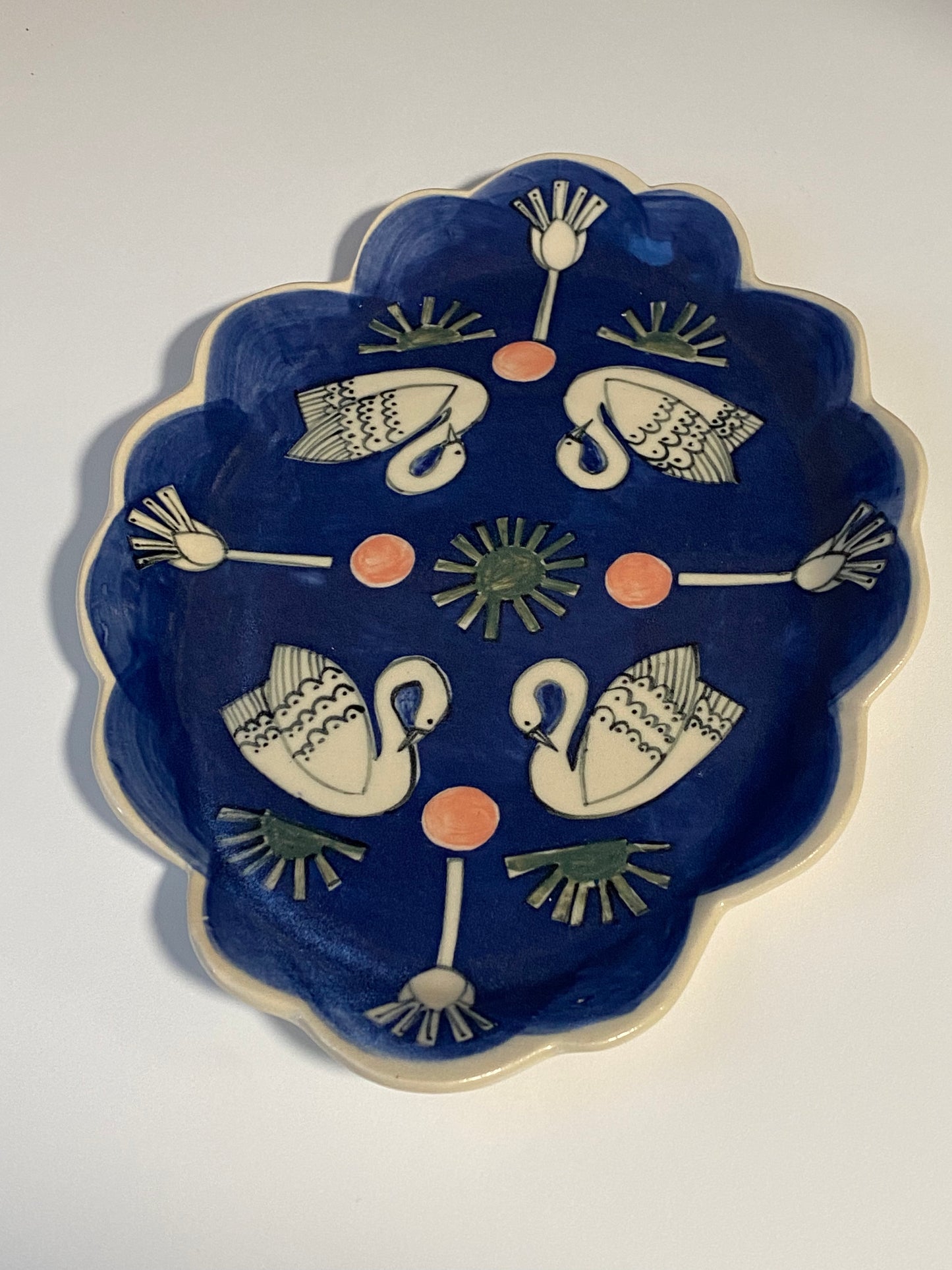 Ceramic Scallop Edge Platter with Swans Pattern against Blue Background