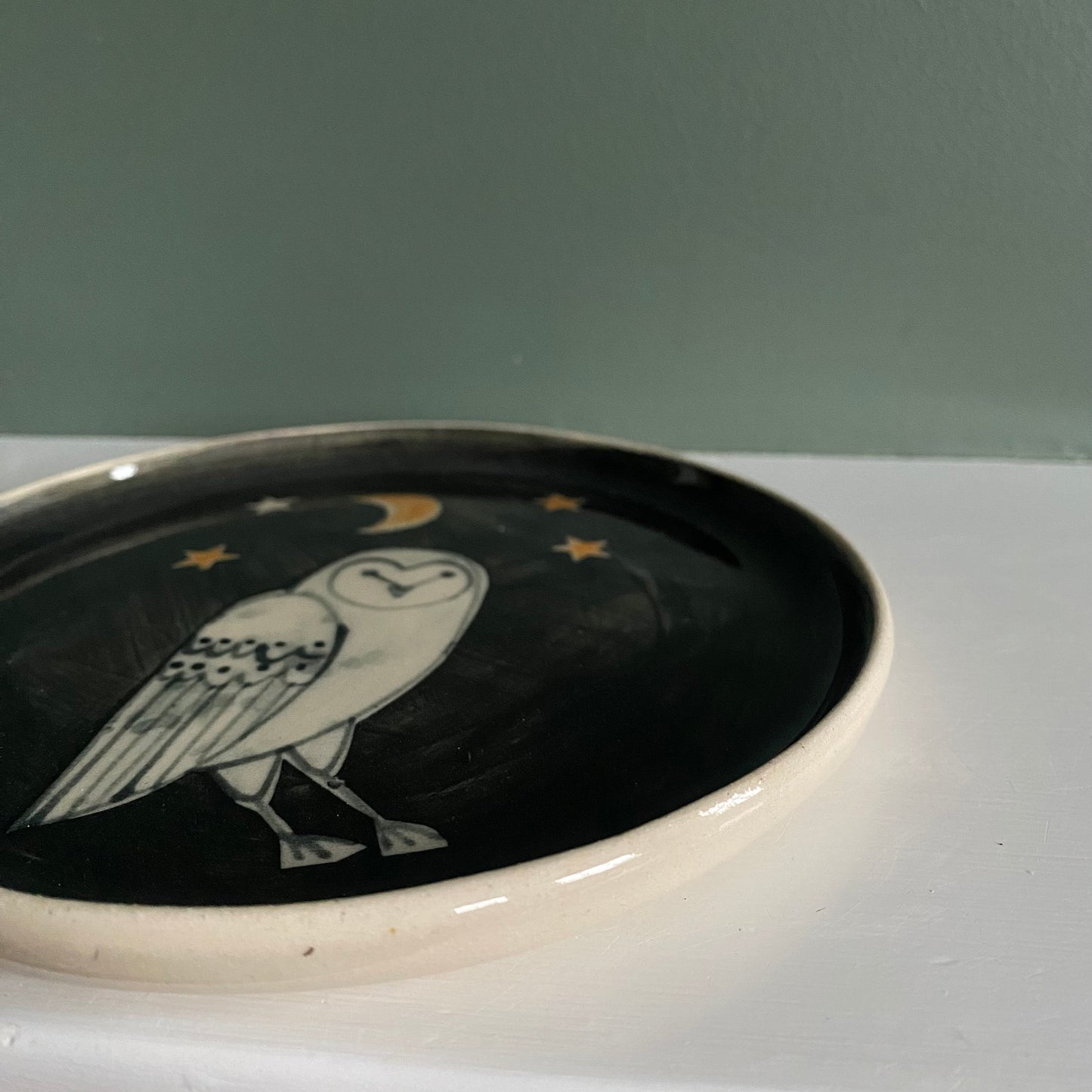 Owl small Stoneware plate with Bird Illustrated round with black background colour and bird line illustration.