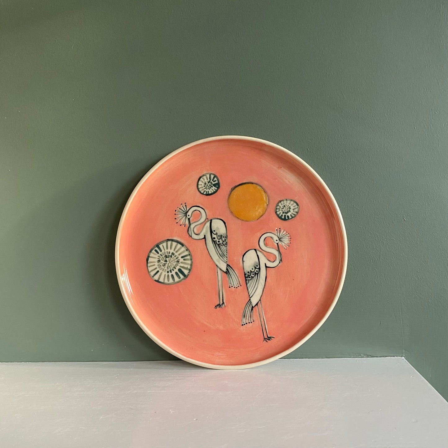 Crane illustrated pink and yellow plate, white stoneware dish